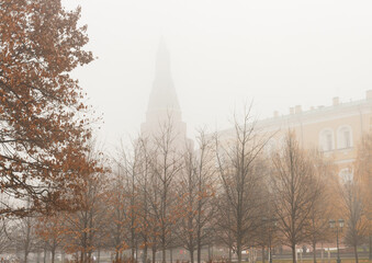 Heavy fog in Moscow, Russia. November. The Kremlin wall in Alexander garden. Arsenalnaya tower...