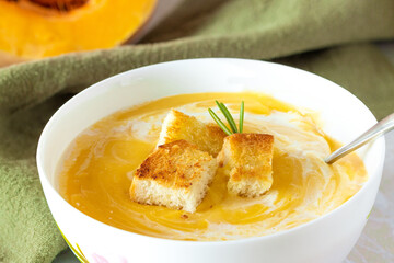 pumpkin soup with cream, wheat crackers and fresh rosemary
