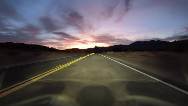 Desert highway dawn driving time lapse on Fort Tejon Road and Valyermo Road near Victorville, California.