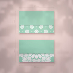 Mint color business card with vintage white ornaments for your personality.