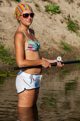 Young lady fishing on the river