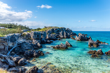 Tobacco Bay's Coastal Charm: St. George's, Bermuda; where sturdy rocks frame azure waters, a picturesque blend of nature's beauty.