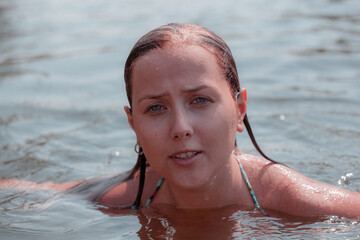 Portrait of a beautiful girl in the river