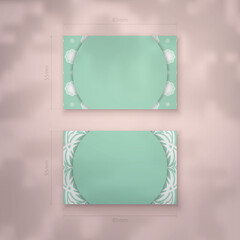 Mint colored business card with Greek white ornaments for your brand.