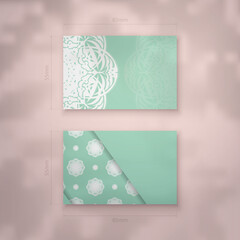Mint colored business card with Indian white ornaments for your business.