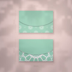 Mint colored business card with luxurious white ornaments for your brand.