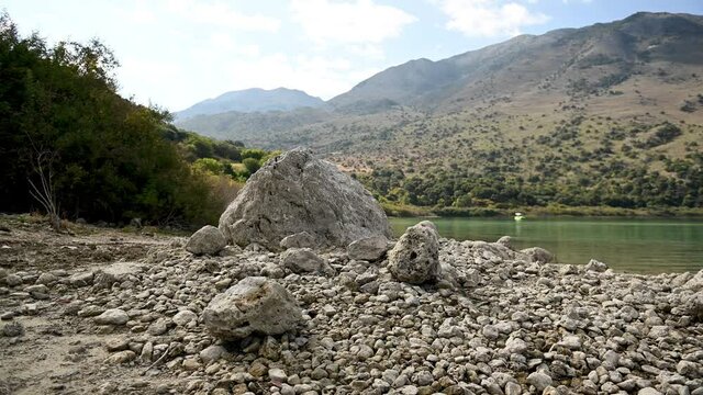 Beige stones on the shores of Lake Kournas in Greece, Crete island.