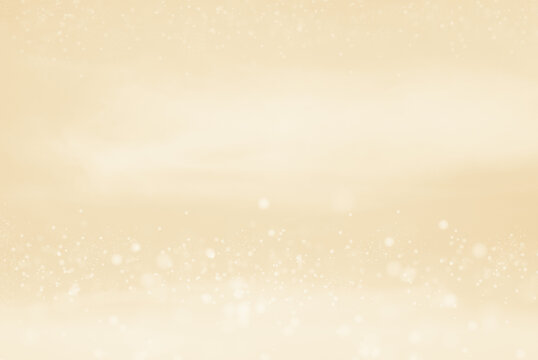 Abstract blurred background in soft pastel tone for autumn and winter design. Snow fall in golden light festive new year atmosphere.