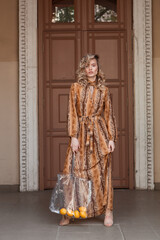Obraz premium Street portrait of a stylish girl with lemons and a leopard dress with blonde hair