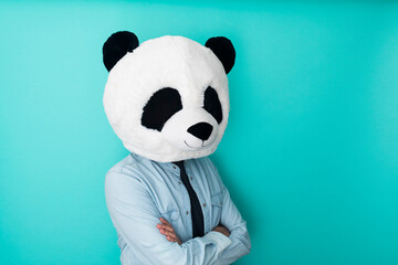 Man in panda mask standing on coloured background. Happy lifestyle concept