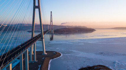 Russian bridge across the Eastern Bosphorus Strait in Vladivostok. View from above. Cars are...