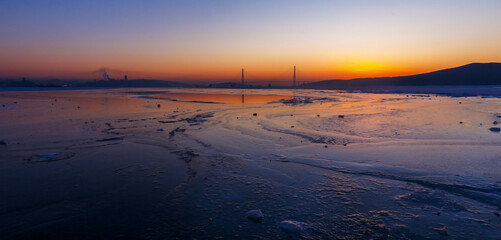 Russian bridge across the Eastern Bosphorus Strait in Vladivostok. General view of the Golden Horn Bay at dawn.