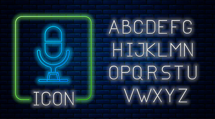 Glowing neon Microphone voice device icon isolated on brick wall background. Microphone interpreter and alphabet letters. Neon light alphabet. Vector