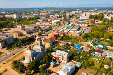 Fototapeta na wymiar RUSSIA, VOLZHSK - AUGUST 23, 2021: Bird's eye view of Russian town Volzhsk. Aerial photo of buildings and streets.