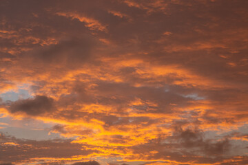 Naklejka na ściany i meble Background of clouds reddish by sunset light.