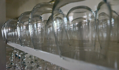 Wine glasses hanging from the shelves.