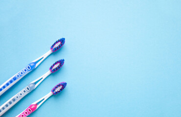 Toothbrushes on a blank blue background. Top view.