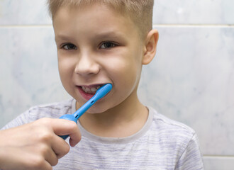 Oral cavity care. Boy brushing teeth