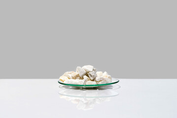 Closeup chemical ingredient on white laboratory table. Calcium carbonate Chip in Chemical Watch...