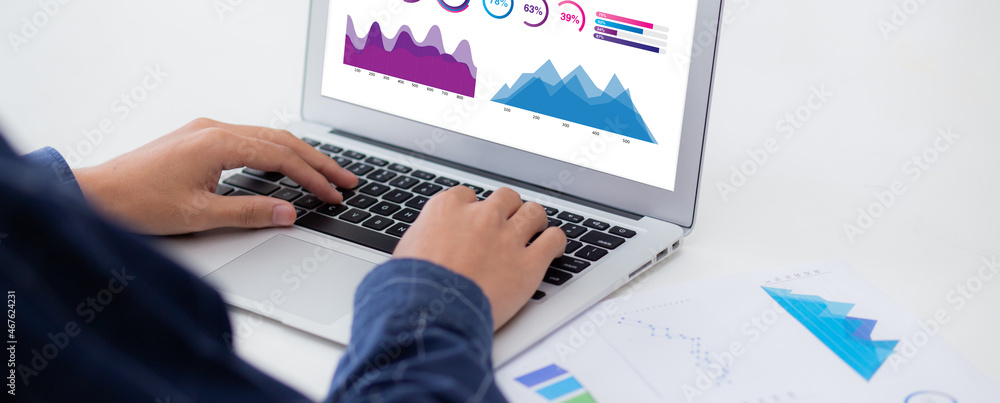 Poster young asian business man working laptop computer blank display screen while report graph and chart p