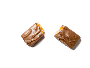 Broken chocolate bar on a white background. Slices of chocolate.