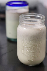 Creamy milkshake, in a transparent glass container.