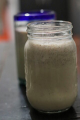 Creamy milkshake, in a transparent glass container.