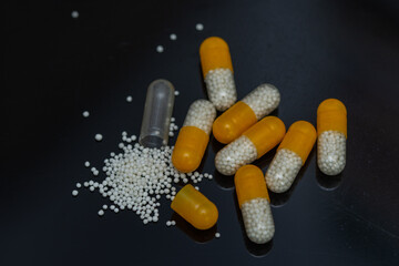 white yellow pills with white granules inside