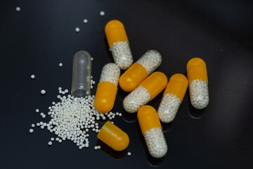 white yellow pills with white granules inside