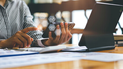 Financial Businesswomen with smartphones analyze the graph of the company's performance to create profits and growth, Market research reports and income statistics, Financial and Accounting concepts.