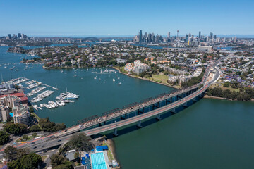 Fototapeta premium The Iron cove bridge over Iron Cove with the city of Sydney in the background.