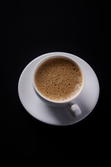 Cup of coffee on black background. Close up. Copy space.
