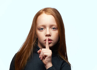 Naklejka premium red-haired girl in a black sweater planning close-up
