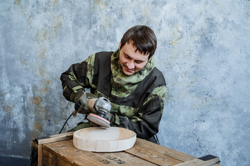 Plate. The master of carving from wood processes a bar of wood. Wood processing and creation of...