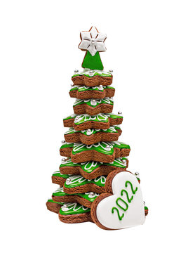 Gingerbread tree with glaze, volumetric. Heart with the year 2022. Isolated on white.