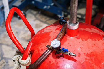 Pneumatic engine oil extractor or waste oil drainer machine in a car repair shop