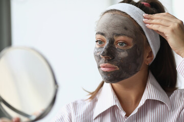 Girl looking in mirror in pyjamas