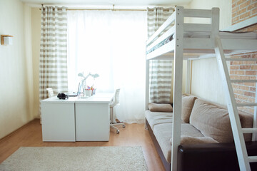 Interior of children room with desk, sofa and bunk bed