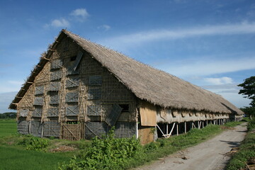 Fototapeta na wymiar Magnificent garden house architecture made from straw or dried coconut leaves. The building is usually functioned as a warehouse as well as drying during the tobacco harvest season. 