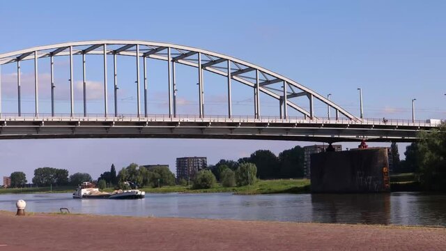 A boat on the river Rhine, John Frost bridge in Arnhem, the Netherlands.