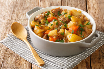 Stovies are a scottish favourite made with potatoes, onions and carrots close up in the pot on the...