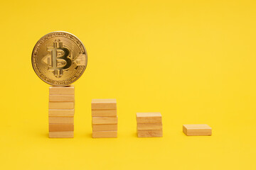 Bitcoin coin on a ladder from wooden blocks