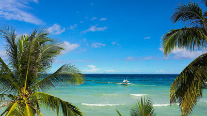 Beautiful tropical beach with white sand, palm trees, turquoise ocean. Panglao island, Bohol, Philippines.