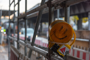A laughing face on a construction site lighting