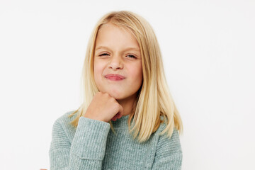 Portrait of a smiling little cutie with blond hair posing studio