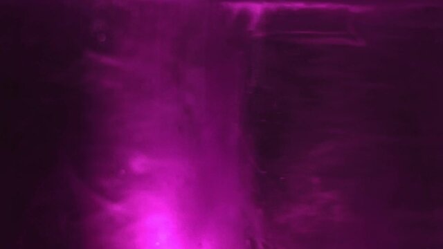 Paint fall into water which is twist. Spin acrylic ink drip into liquid. Visual effect bullet time, frozen moment, flow motion. Cloud fraction of color is spray drop. Slow motion cosmic video magic.