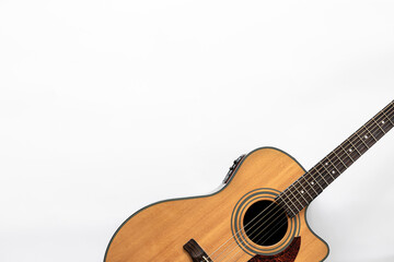 Fototapeta na wymiar Acoustic guitar on a white background, top view, copy space.