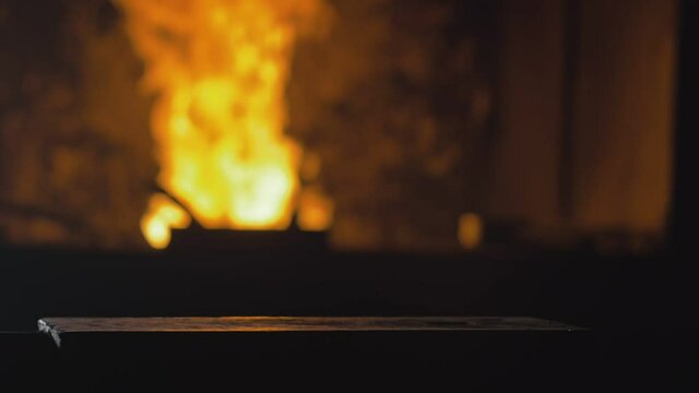 Forge workshop. Smithy manual production. Hands of smith with hammer hit on glowing hot metal, on the anvil, the forging process. Blacksmith makes iron products for manufacture of fireplace, stove.