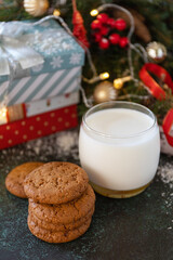 Obraz na płótnie Canvas Homemade Cookies and milk for Santa Clause near the Christmas tree with present. Holiday concept.