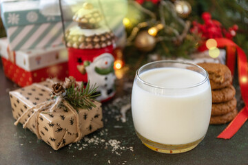 Homemade Cookies and milk for Santa Clause near the Christmas tree with present. Holiday concept.